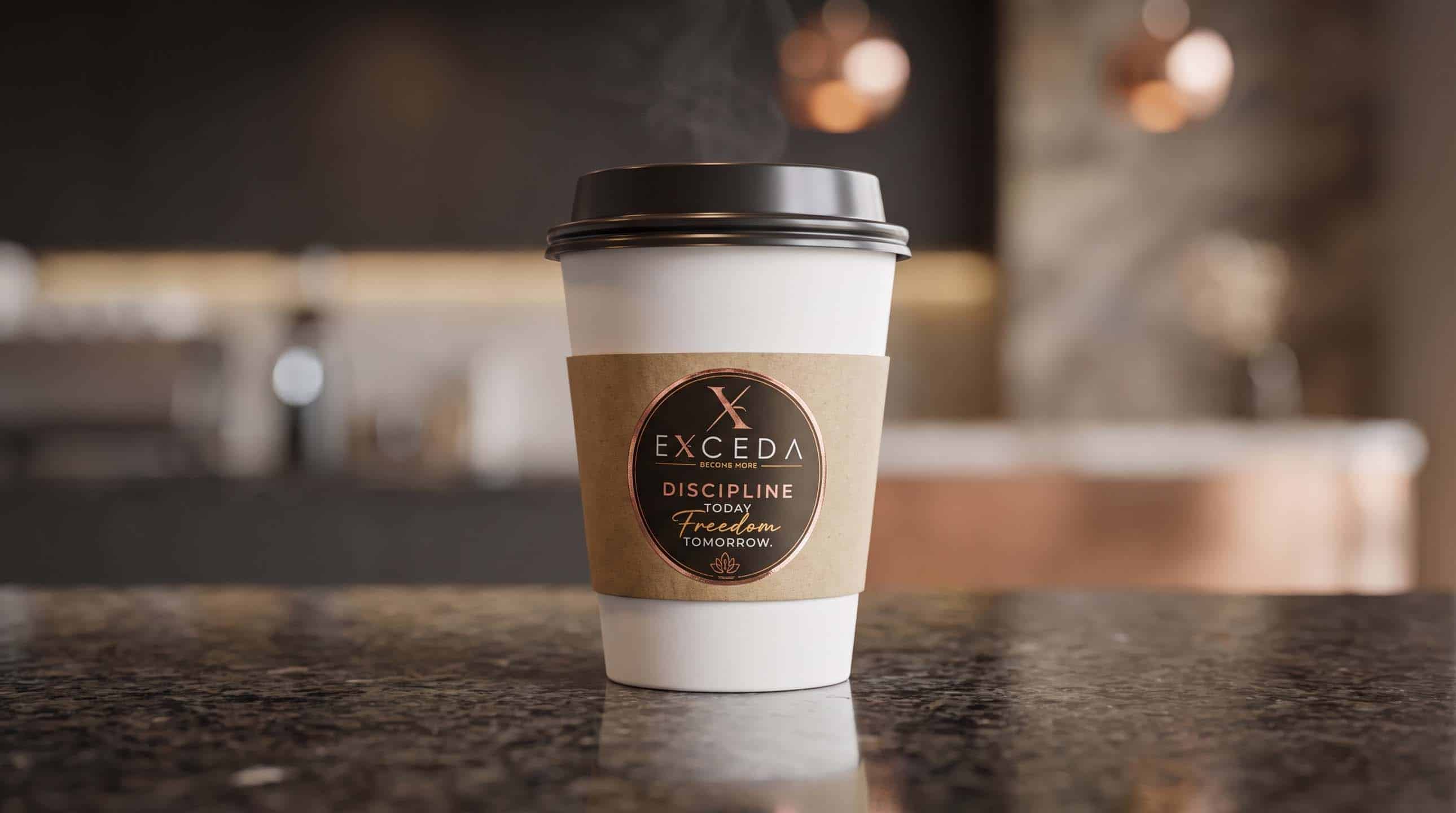 An Exceda cup with a kraft sleeve and the Become More roundel, steaming on a counter.